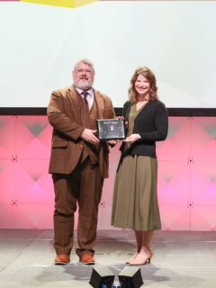 Man and woman holding award plaque