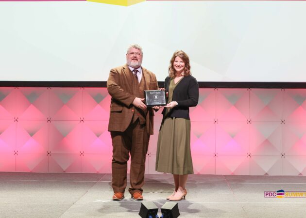 Man and woman holding award plaque